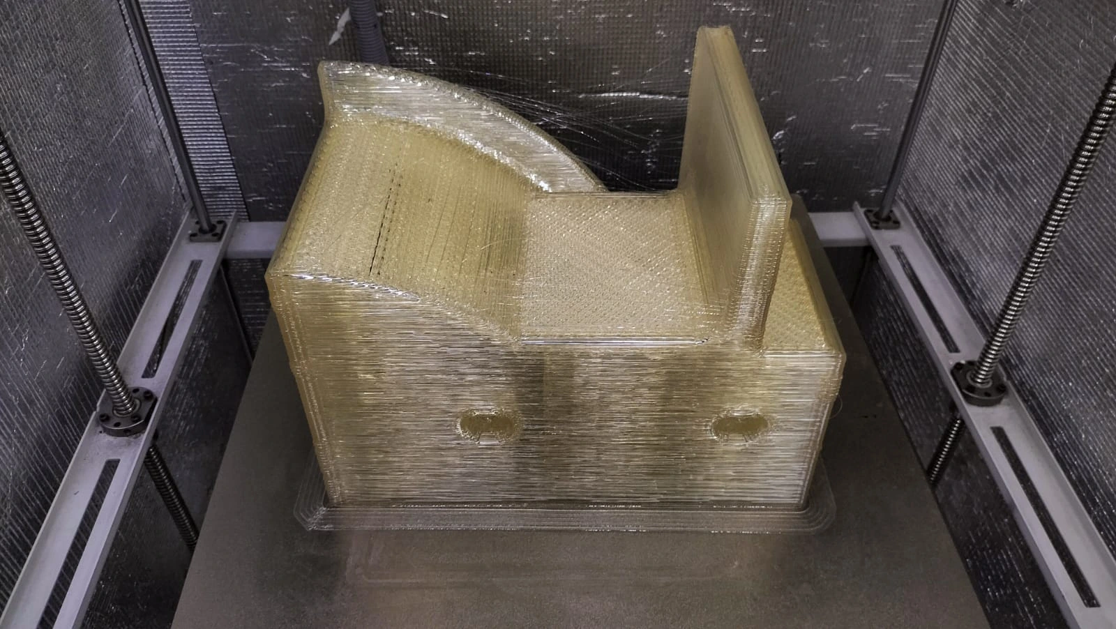 Large-format pellet 3D printed chair, an example of pellet-scale output vs. filament