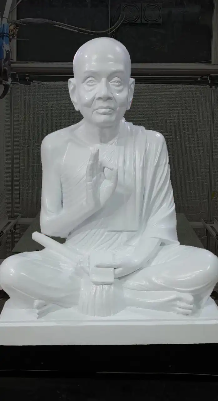 Life-size 3D printed statue of a seated swamiji with detailed robe and facial features